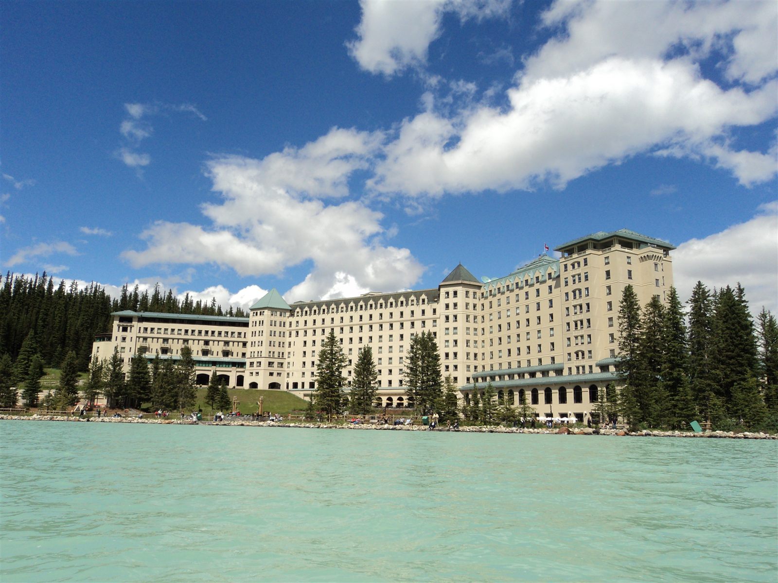 A grand lakeside château below glacier peaks